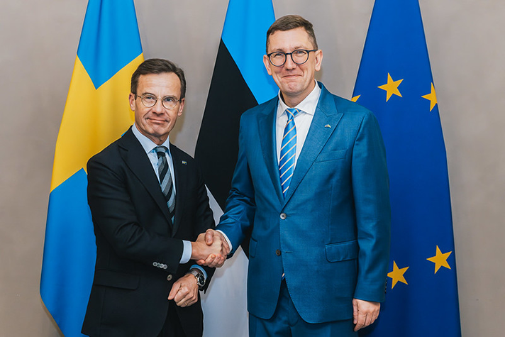 Ulf Kristersson och Kristen Michal står inomhus och skakar hand. Bakom dem syns Sveriges flagga, Estlands flagga och EU:s flagga.