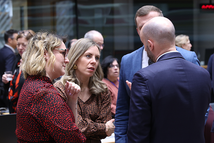 Jessica Rosencrantz samtalar med kollegor i ett mötesrum.