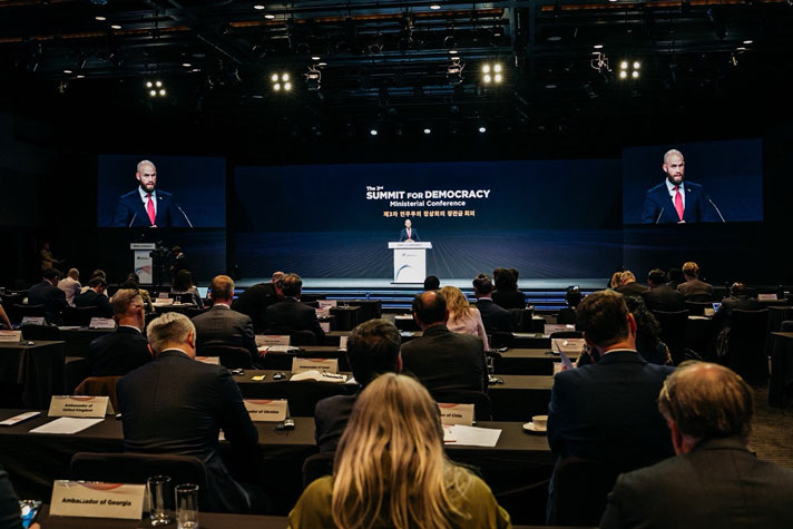 Carl-Oskar i en talarstol framför publik.