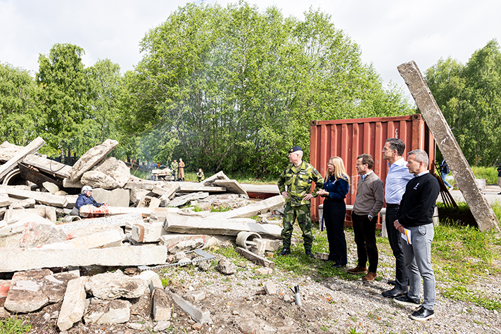 Ulf Kristersson och Mark Rutte står utomhus och tittar på en militärövning.
