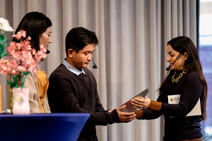 Bild på när kulturminister Parisa Liljestrand lämnar över Per Anger-priset till representanter för pristagaren Sithar Chhim. 